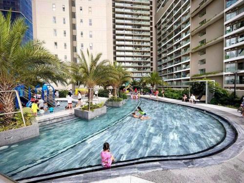 a large swimming pool in a resort with people in it at The Sóng Vũng tàu -Thuỷ còi in Vung Tau