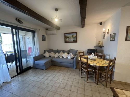 un salon avec un canapé et une table dans l'établissement Appartement à proximité de la plage, à Saintes-Maries-de-la-Mer