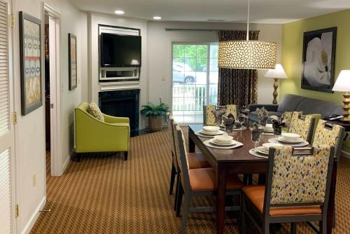 a dining room and living room with a dining table at Vacation Village at Williamsburg in Williamsburg