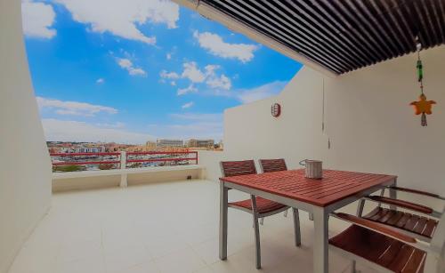 a room with a table and chairs on a balcony at Penthouse Triplex L25 T2 by HsR Vilamarina in Vilamoura
