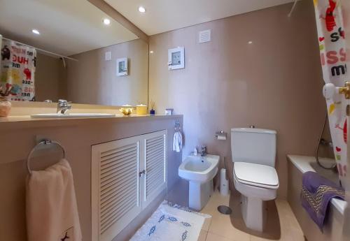 a bathroom with a sink and a toilet at Penthouse Triplex L25 T2 by HsR Vilamarina in Vilamoura