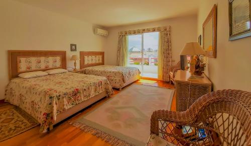 a bedroom with two beds and a window at Penthouse Triplex L25 T2 by HsR Vilamarina in Vilamoura