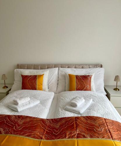 a bedroom with two beds with towels on them at Engler Apartments in Zizers