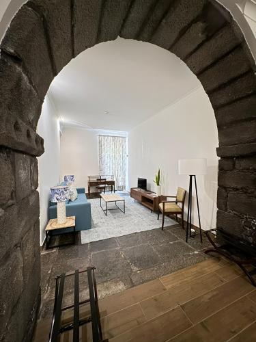 a living room with a couch and a table at Casa do Campo de São Francisco in Ponta Delgada