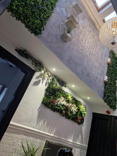 a room with a bunch of plants on the wall at Albert Rd Aparthotel in Colne