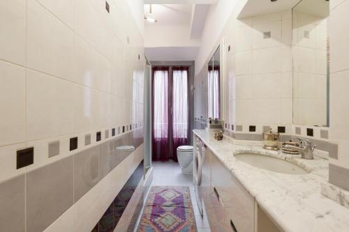 a white bathroom with a sink and a toilet at Milan Retreats in Milan