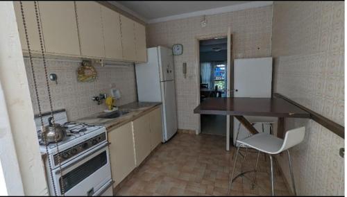 a small kitchen with a stove and a counter top at Depto Playa Grande in Mar del Plata