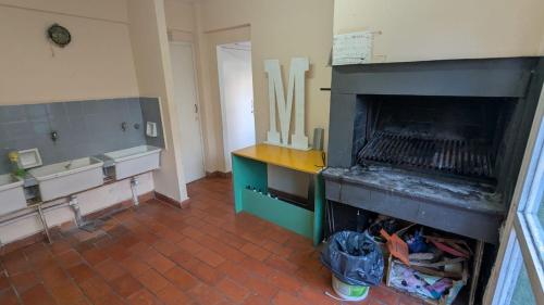 a room with a fireplace with wooden utensils at Depto Playa Grande in Mar del Plata