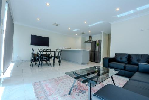 a living room with a couch and a table at Spectacular 3 Bedroom, 2 Bathroom Home. in West Swan