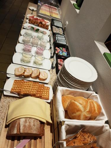 a buffet line with various types of bread and pastries at Hotel Landgasthof Hirsch in Marktlustenau