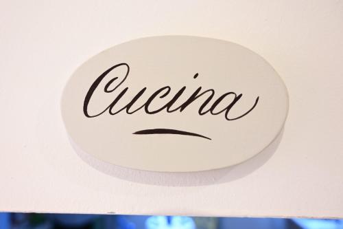 a sign with the word urina on a wall at La Garampa in Cesena
