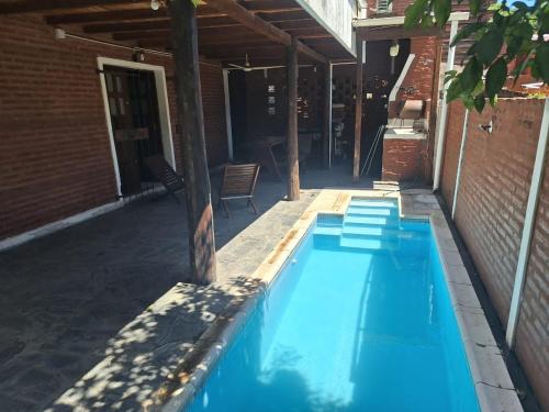 a large blue swimming pool on a patio at Hermosa Cabaña Paso Patria in Paso de la Patria