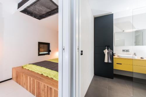 a bedroom with a bed and a sink at Luxury Holiday Home Itana with Private Pool and Sea View in Dragove