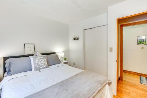 a bedroom with a large white bed with blue pillows at Peaceful 1-Acre Parksville Home Large Deck and Yard in Parksville