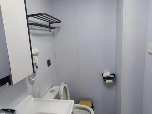 a bathroom with a white toilet and a mirror at Xiaobin 6号 in Datong