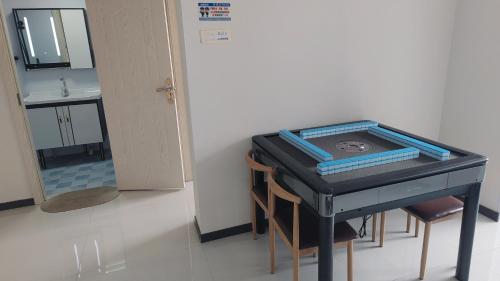 a room with a table with a sink and a mirror at Xiaobin 6号 in Datong