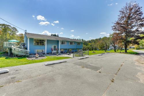 a blue house with a parking lot at Peaceful 1-Acre Parksville Home Large Deck and Yard in Parksville
