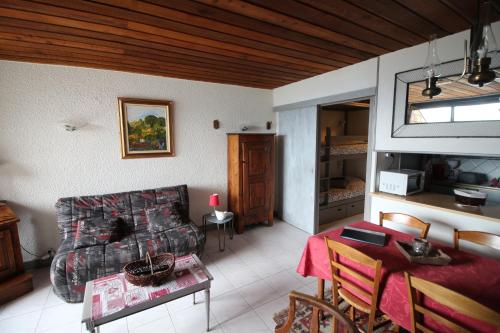 un salon avec un canapé et une table dans l'établissement Praloup 1600 joli studio vue panoramique, à Pra-Loup