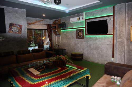 a living room with a couch and a flat screen tv at Mountain View Party Hostel in Ao Nang Beach