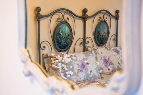 a bed with three mirrors on top of it at La Garampa in Cesena