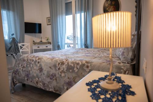 a bedroom with a bed and a table with a lamp at La Garampa in Cesena