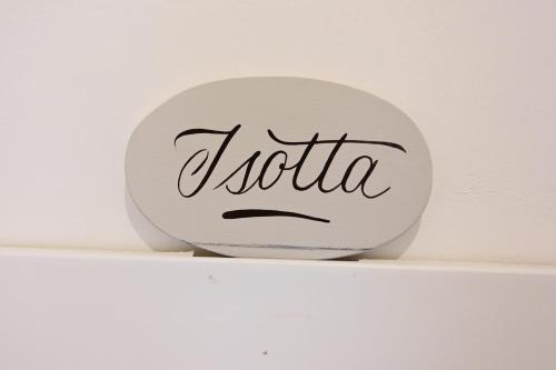 a white plate with the word kotula on a shelf at La Garampa in Cesena