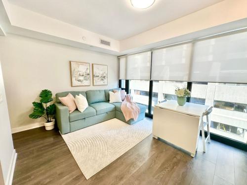 a living room with a couch and a table at Condo in Yorkville - Newly Furnished Luxury Unit in Toronto