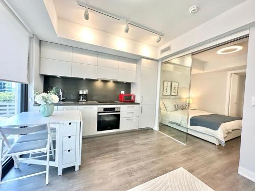 a kitchen with a desk and a bed in a room at Condo in Yorkville - Newly Furnished Luxury Unit in Toronto
