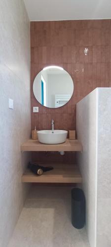 une salle de bain avec un lavabo et un miroir dans l'établissement Heron- Maison avec jacuzzi privatif 4pers, à Les Sables-dʼOlonne