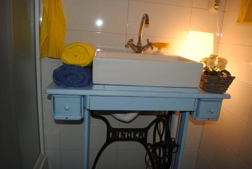 a sink in a bathroom with a blue table at Lui in Makarska