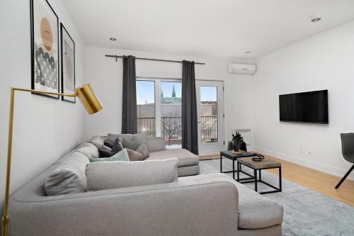 a living room with a couch and a flat screen tv at 3 bedroom Penthouse Great for family vacation in Montréal
