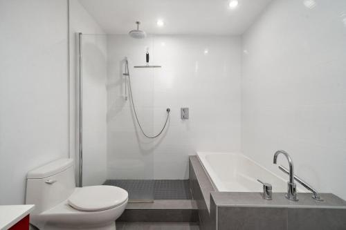 a bathroom with a shower and a toilet and a tub at 3 bedroom Penthouse Great for family vacation in Montréal