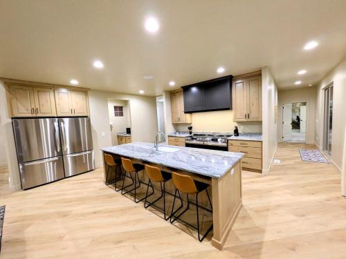 a large kitchen with a large island with bar stools at BRAND NEW World Adventure at Aspen Crest in Beaver