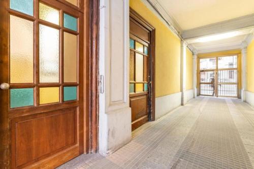 an empty hallway in an old building with a door at Grazioso Room in Milan