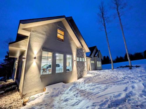 a house in the snow at night at BRAND NEW World Adventure at Aspen Crest in Beaver