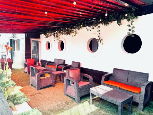 a group of chairs and tables on a patio at Wiseville hotels&Apt's in Asaba
