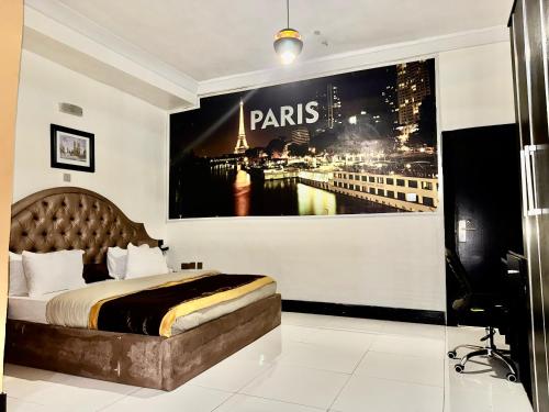 a bedroom with a poster of the paris skyline at Wiseville hotels&Apt's in Asaba