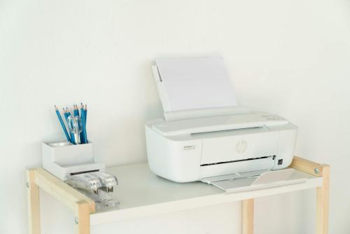 a printer sitting on top of a wooden table at Outsite Puerto Rico - San Juan in San Juan