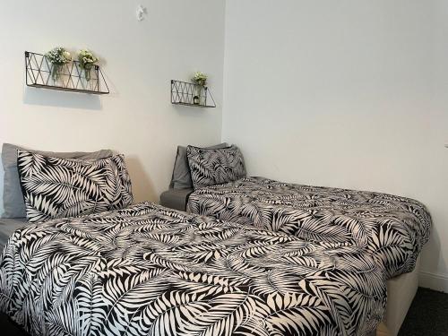 a bed and a couch in a room with a blanket at BH2 Beach House in Bournemouth
