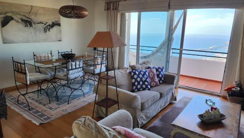 a living room with a couch and a table at Murteiras Living in Funchal