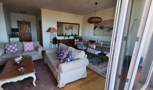 a living room with a couch and a table at Murteiras Living in Funchal