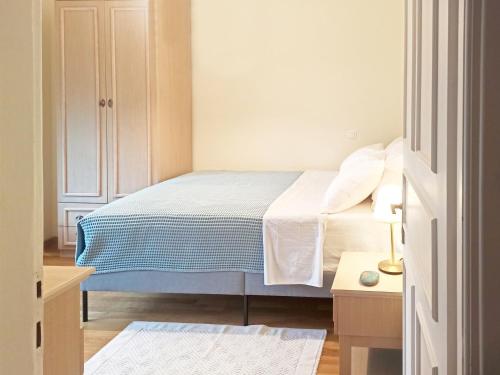 a bedroom with a bed with a blue and white blanket at Beautiful house with garden and amazing lake view in Kastoria