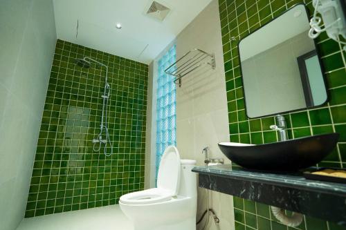 a bathroom with a sink and a toilet and a mirror at Charm Vân Long in Ninh Binh