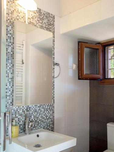 a bathroom with a sink and a mirror at Beautiful house with garden and amazing lake view in Kastoria