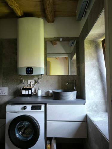 a kitchen with a sink and a washing machine at Appartamento 1 Sottocastello in Pieve di Cadore