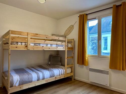 a bedroom with two bunk beds and a window at Maison le B - Disneyland Paris - Parking - Wifi in Bussy-Saint-Georges