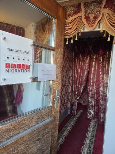 a sign on the door of a room with curtains at Villa de Maître in Bern in Bern