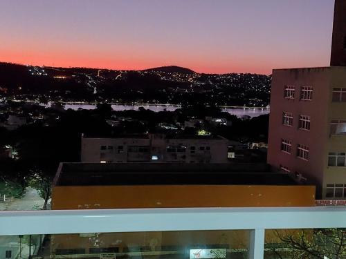 a view from the roof of a building at sunset at Flats da Júnia no Paris Residence in Lagoa Santa