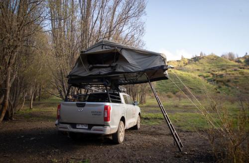 a truck with a tent on the back of it at Camper camioneta equipada cajon del maipo in San José de Maipo
