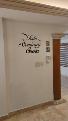 a wall with a sign on a wall at Cumbresuites in Monterrey